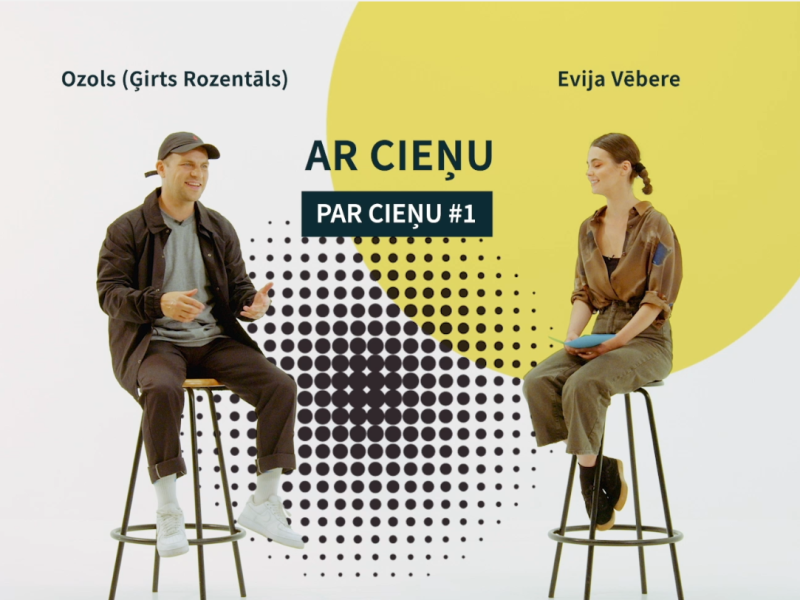 Divi cilvēki - Ozols (Ģirts Rozentāls) un Evija Vēbere - sēž uz ķebļiem uz balta fona ar dzeltenu apli. Uzraksts "Ar Cieņu" un "Par Cieņu #1". Abi šķiet iesaistīti sarunā.